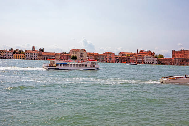 public water transport floats along a canal in Venice