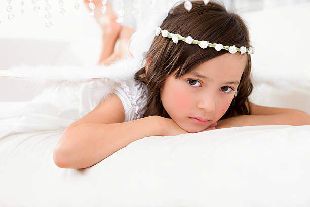 istock Young girl angel laying on couch 186710619
