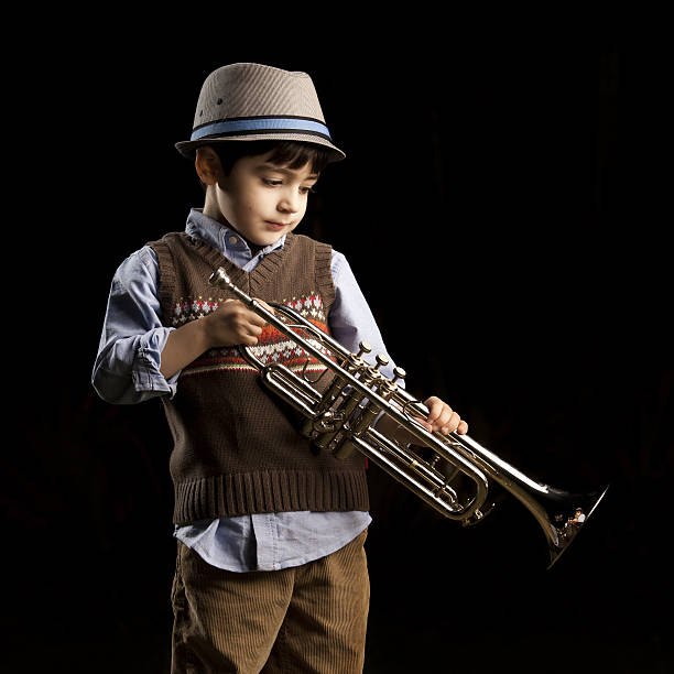 istock four years old kid with a trumpet 186711328