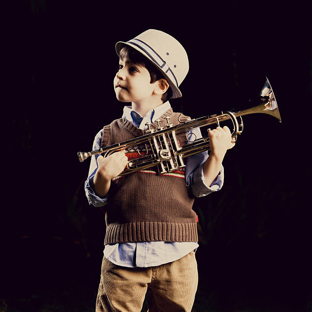 istock four years old kid with a trumpet 186711339