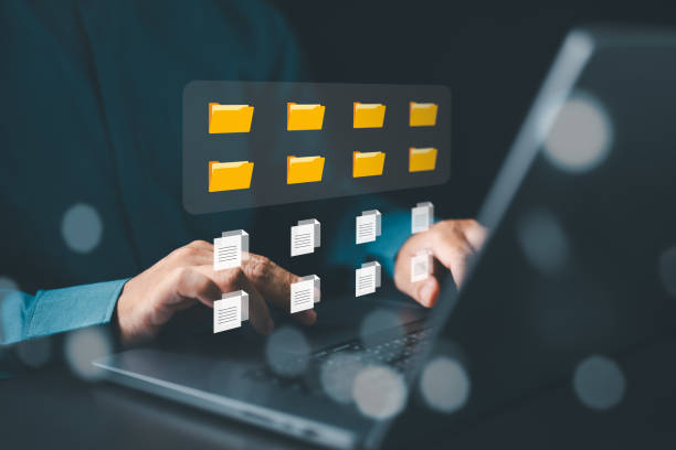 istock Businessman with Document Management System, DMS. Enterprise resource planning (ERP) and content management. Document searching, sharing, backup online files with cloud server for efficient archiving. 1867119986