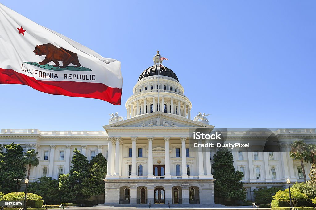 California state flag flying in front of capital building Sacramento California outside capital building California Stock Photo