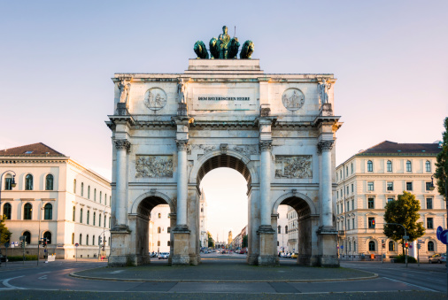 Siegestor triumphal arch in Munich, Germany at dusk.
