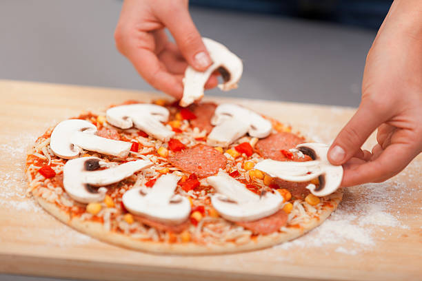 istock Young woman preparing pizza 186714878
