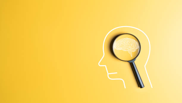 istock Human head with brain icon inside magnifier on yellow background. Creative idea thinking, Awareness of Alzheimer's, Parkinson's, neurology, brain diseases cognitive problems, and psychology care. 1867151735