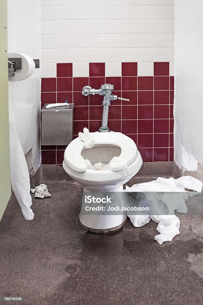 Public restroom needs cleaning Toilet stall in a public restroom needs to be cleaned.  RM Clogged Stock Photo