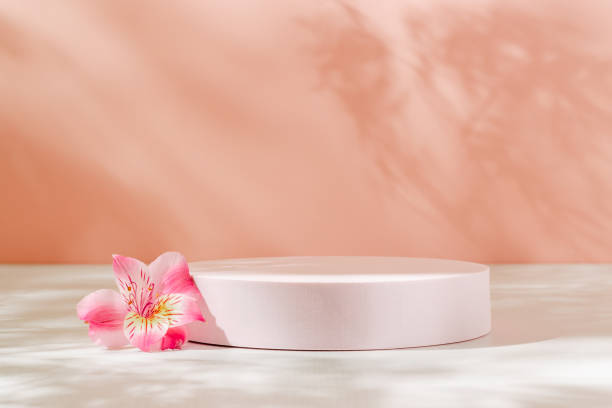 istock Empty podium with pink lily flower and aesthetic sunlight shadows. 1867178227