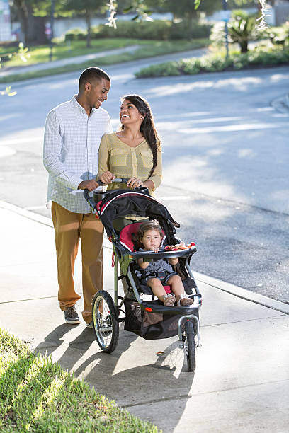 istock Young family with baby in stroller 186718225