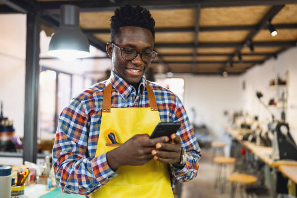 istock Male tailor African-American ethnicity using mobile phone 1867184761