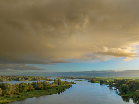 Rain clouds during an autumn rain shower in the afternoon over the river IJssel near Zwolle in Overijssel, Netherlands.