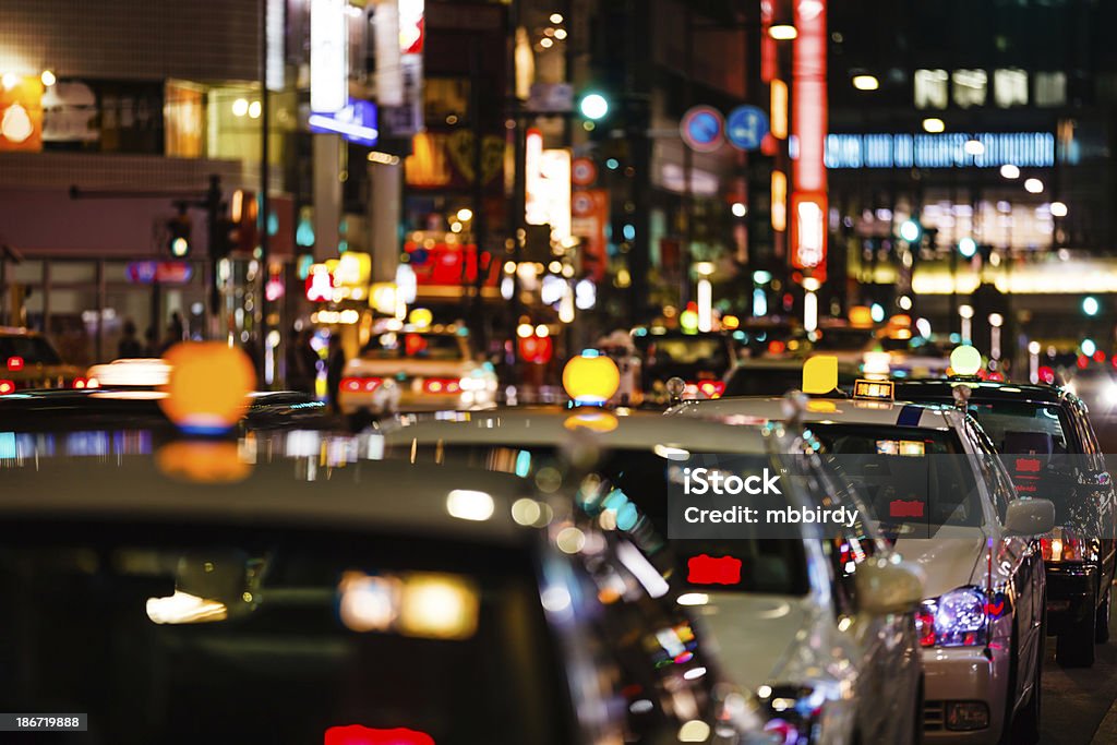 Taxis at night in Tokyo Parked taxis waiting for customers at night in Tokyo, Japan. Shallow DOF, selective focus. Taken on iStockalypse Tokyo, Japan, 2010. http://santoriniphoto.com/Template-istockalypse-tokyo-2010.jpg Taxi Stock Photo