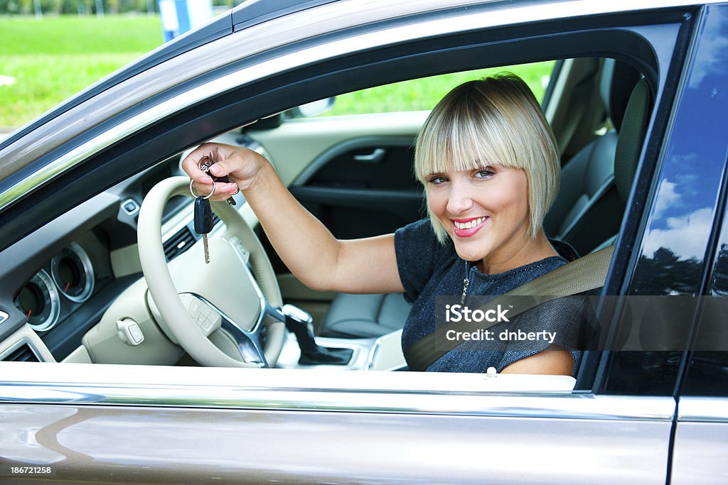 woman driver with car key attractive blond woman with car key in driver seat exited Adult Stock Photo