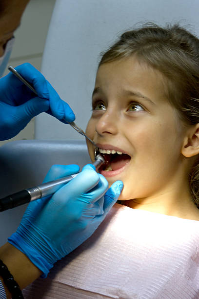 istock girl at the dentist. 186721513