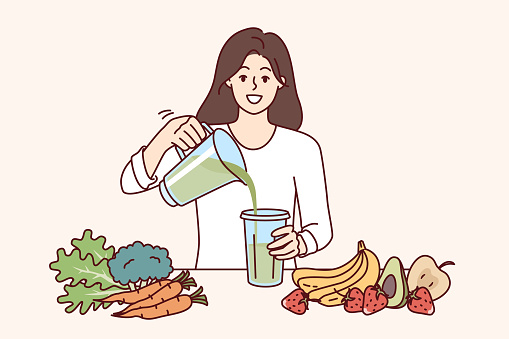 Woman drinks diet smoothie made in blender from organic fruits and vegetables with healthy vitamins. Cheerful girl uses detox diet to get rid of excess weight or harmful toxins in body