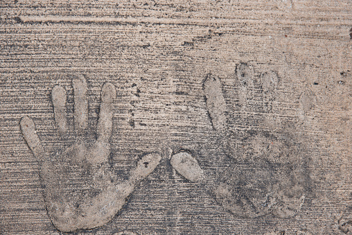 Handprints in brushed concrete. Textured.
