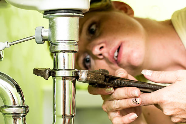 istock Housewife repairing a siphon under the sink 186723316