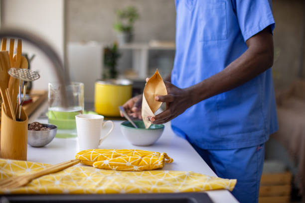 Young male nurse making himself breakfast at home