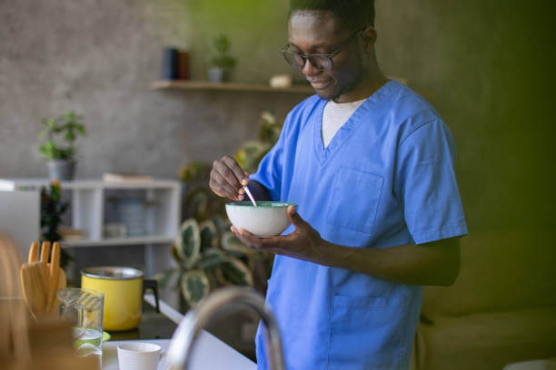 istock Young male nurse making himself breakfast at home 1867233763