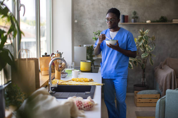 istock Young male nurse making himself breakfast at home 1867233765