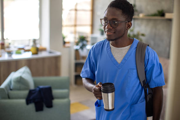 Young medical school student wearing medical scrubs getting ready for school