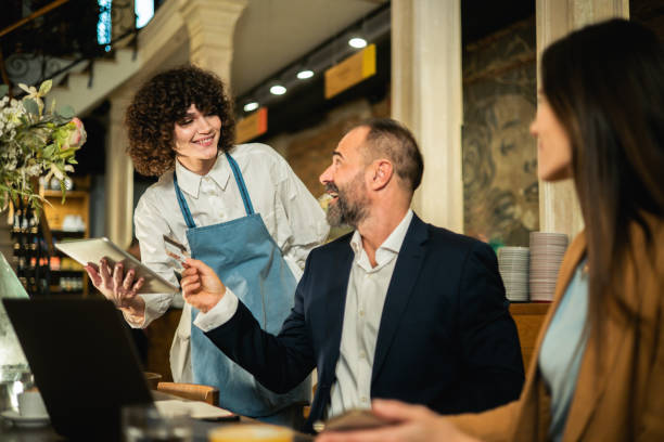 istock Two business people ordering a meal while working together at the restaurant 1867236034