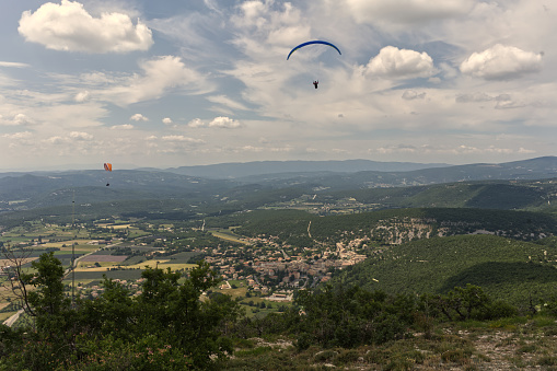 Group of paragliders enjoy a thermal updraft in Puy de Dome, Auvergne, French Massif Central. France