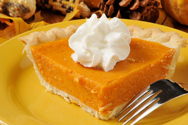 Closeup of a slice of sweet potato pie with shipped cream