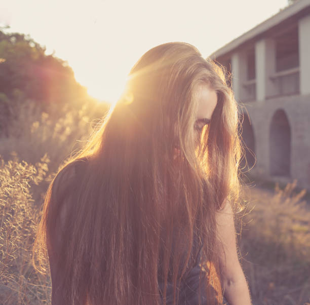 istock blonde at autumn sunset 186724705
