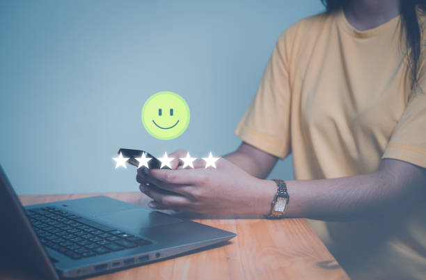 istock Customer service experience and business satisfaction survey, close up  hand using smart phone and give five star symbol to increase rating of product and service concept. 1867256558