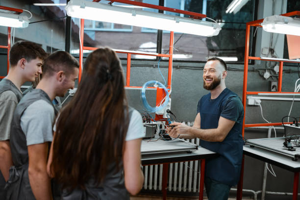 istock Teacher Explaining The Ins And Outs Of A PLC To Electrical Engineering Students 1867263256