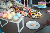 Assorted French Macarons and Sandwiches at Diverse Party Buffet