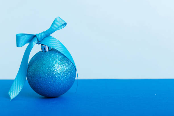 Christmas blue baubles on the wooden background