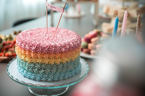 Close up young man carrying a birthday cake in a surprise party