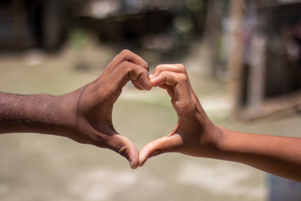 istock two people has love sign with hand and blurred background 1867274014