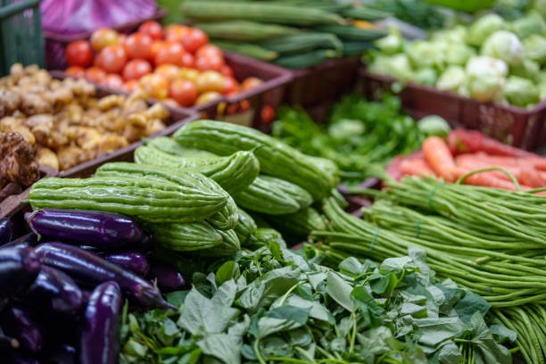 An array of multi-colored fruits and vegetables showcased on a market stall in Penang, Malaysia.