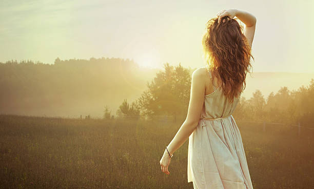 istock Pretty brunette woman watching the sunset 186728311