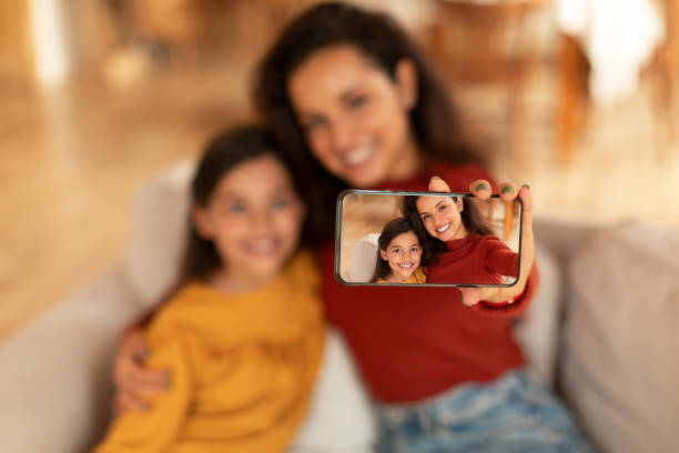 istock Middle Eastern Mom And Daughter Making Selfie Via Phone Indoor 1867283637