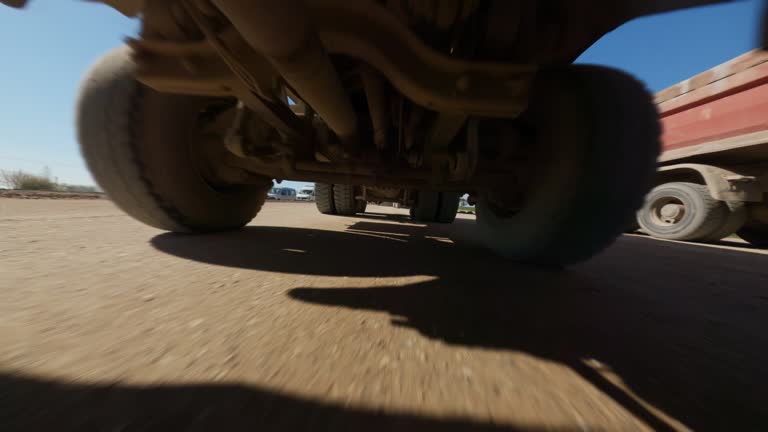 FPV drone flight view construction site of a new asphalt highway. Trucks carrying construction materials cargo