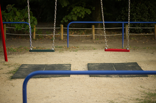 Swings in outdoor play sand pool