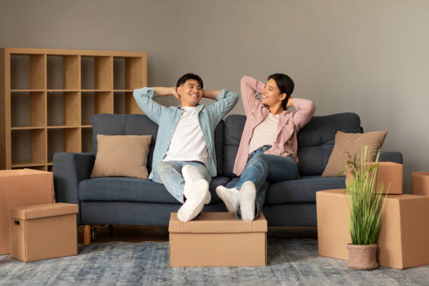 istock Happy Korean Couple Resting Leaning On Couch At Home 1867299912