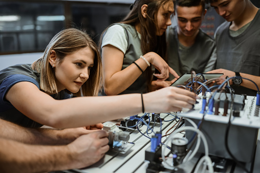 Female Student Demonstrating Deep Concentration While Operating PLC Device