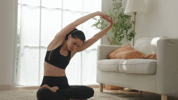 istock Focused Flexibility, Side Stretch Yoga Pose in Sunlit Room 1867312788