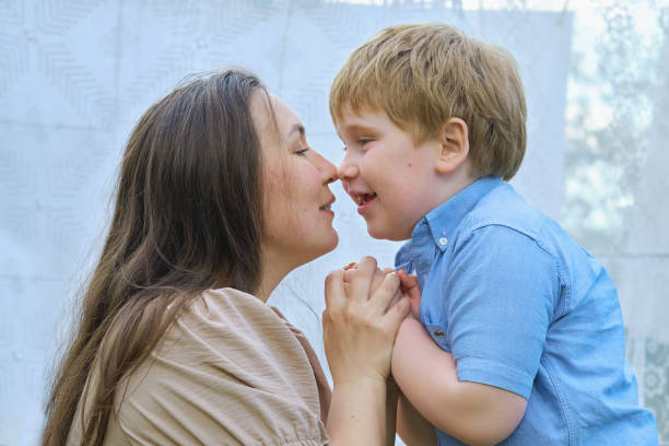 istock Under a cloudy summer sky, amid fresh laundry, a joyful play ensues between a mother and her redhead son. The setting and their happiness bring focus to the importance of eco-conscious living. 1867319366