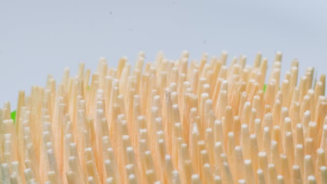 Macro video of a toothpick on a white background. Wooden sticks for cleaning teeth