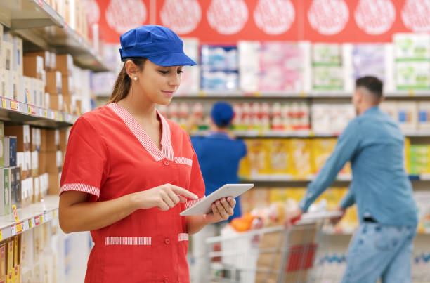 istock Supermarket clerk using a digital tablet 1867327936