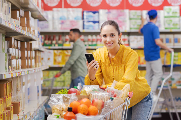 istock Happy customer doing grocery shopping and using her smartphone 1867331635