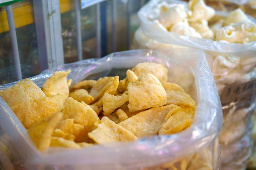 Dried fish maw is available for sale at an Asian market stall. Fish maw, also known as fish bladder, is a popular ingredient in Asian cuisine, valued for its unique texture and flavor. It is often used in soups, stews, and other dishes, prized for its nutritional benefits and culinary versatility.