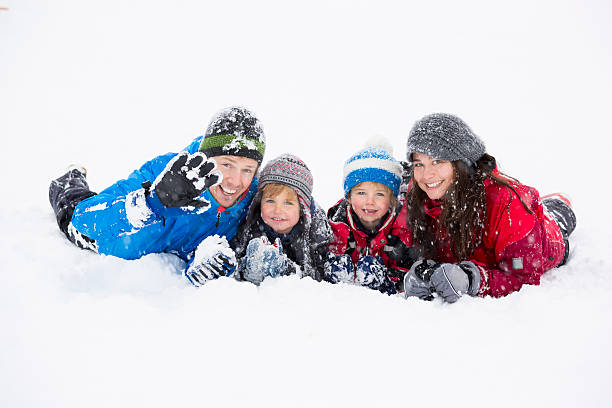 istock Happy family having fun in snow 186735142
