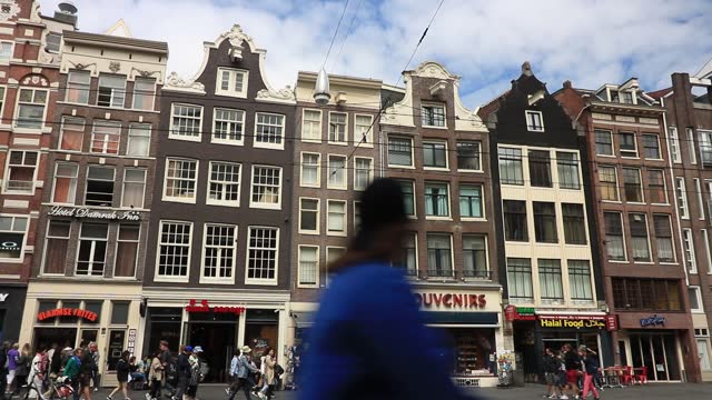 Ancient houses on a main street in Amsterdam.