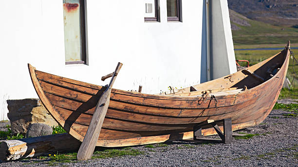 istock Wood boat lying next to a building. 186735507